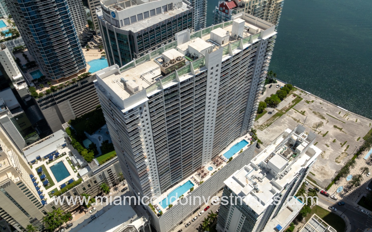 The Club at Brickell Bay drone closeup looking down at condo building exterior and pools
