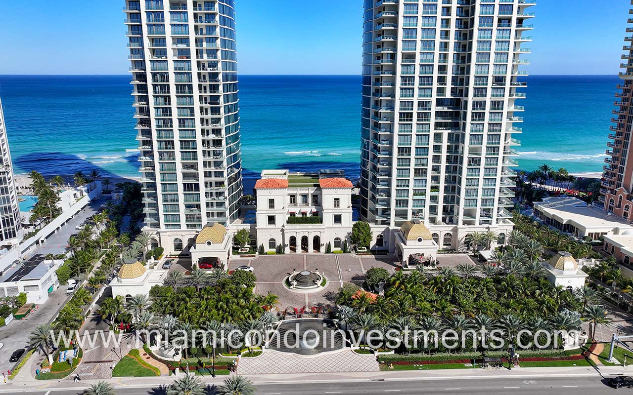 The Estates at Acqualina drone facing building front entry with blue ocean backdrop