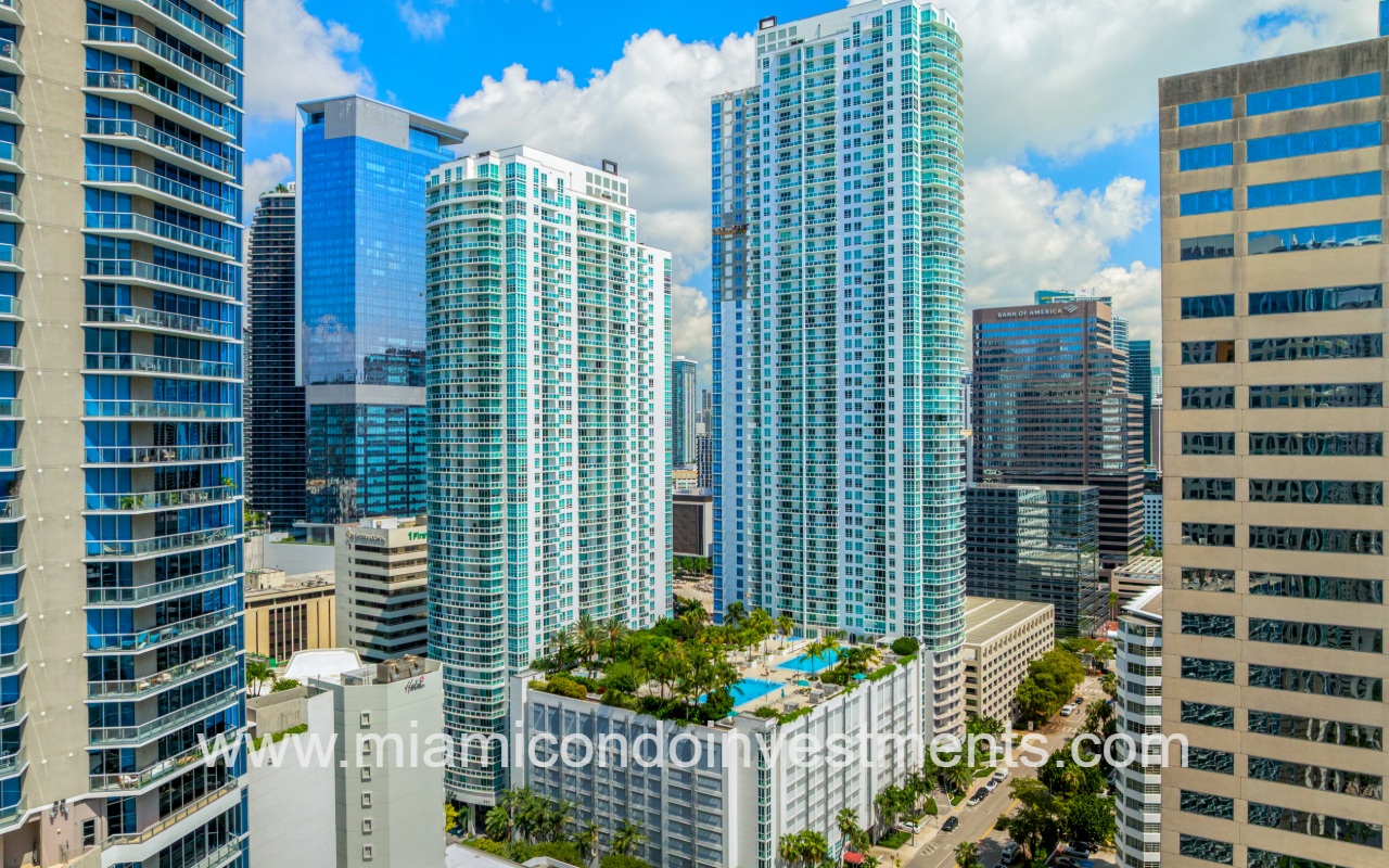 The Plaza on Brickell West drone aerial view of condo building and bay in the background