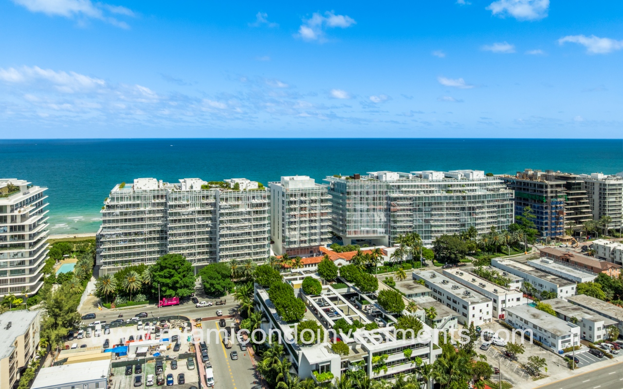 The Surf Club Four Seasons drone view of front of condo building with blue ocean backdrop