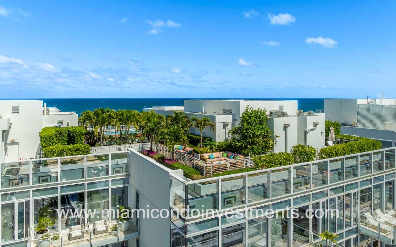 The Surf Club Four Seasons drone closeup overlooking rooftop of north condo building