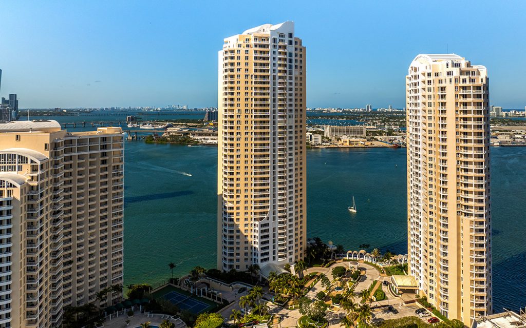 Three Tequesta Point drone view facing front angle of building with waterfront backdrop