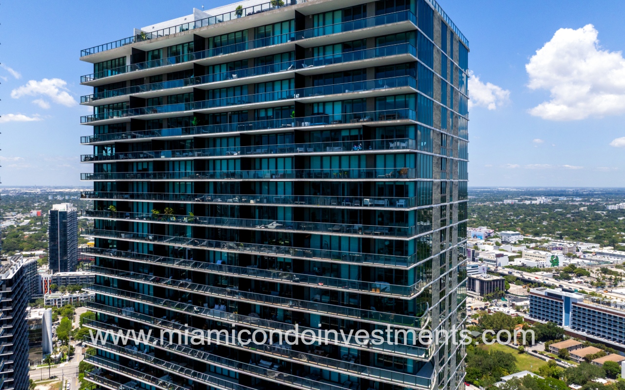 Paraiso Bay drone facing top part of condo building exterior closeup