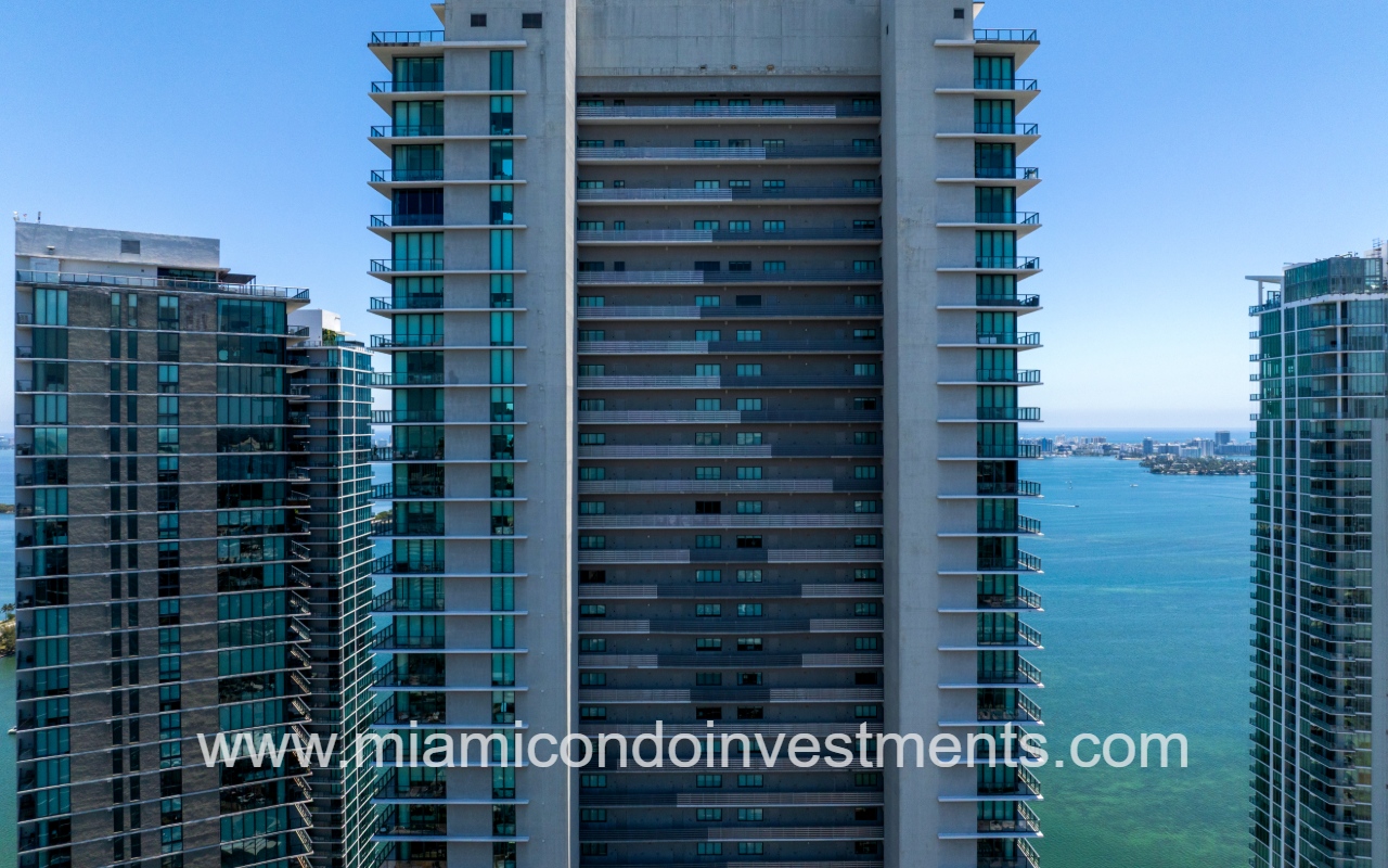 Paraiso Bay drone facing top half of condo building exterior