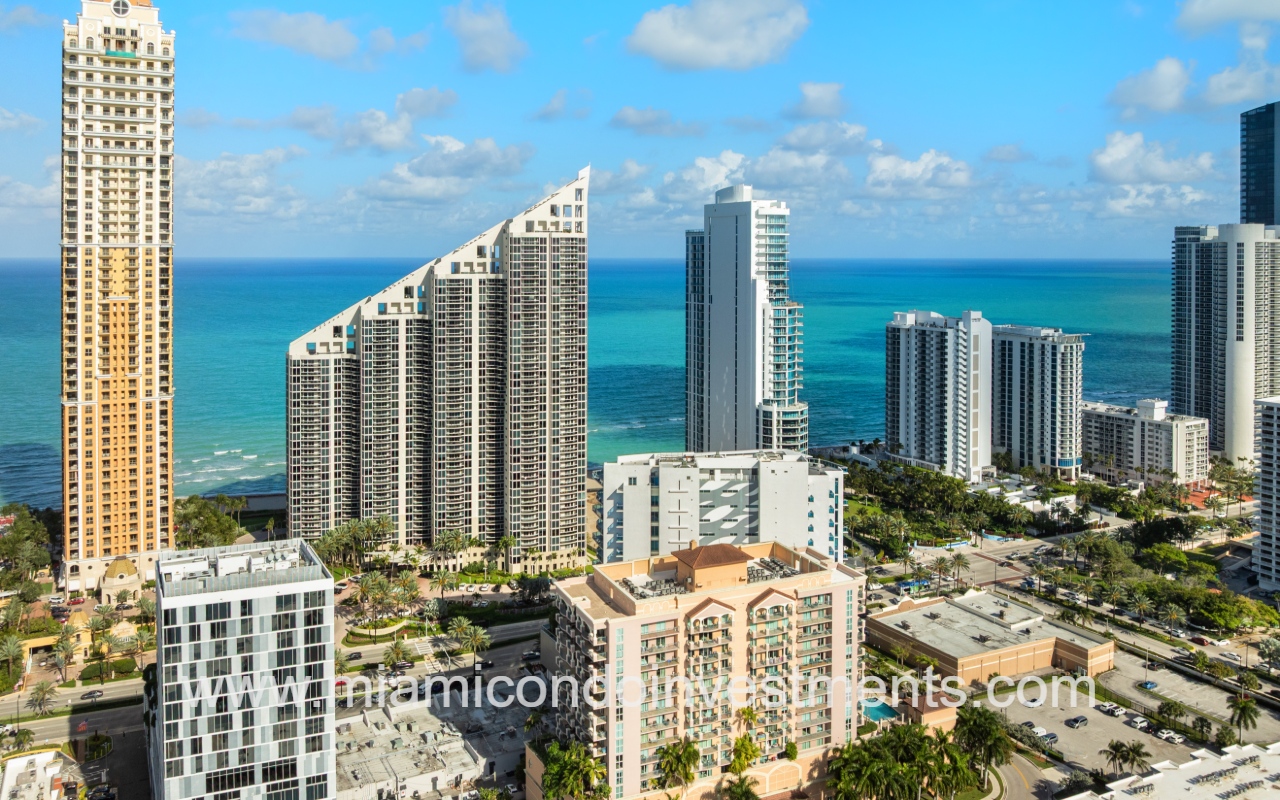 Aurora condo building drone view of area with ocean in background
