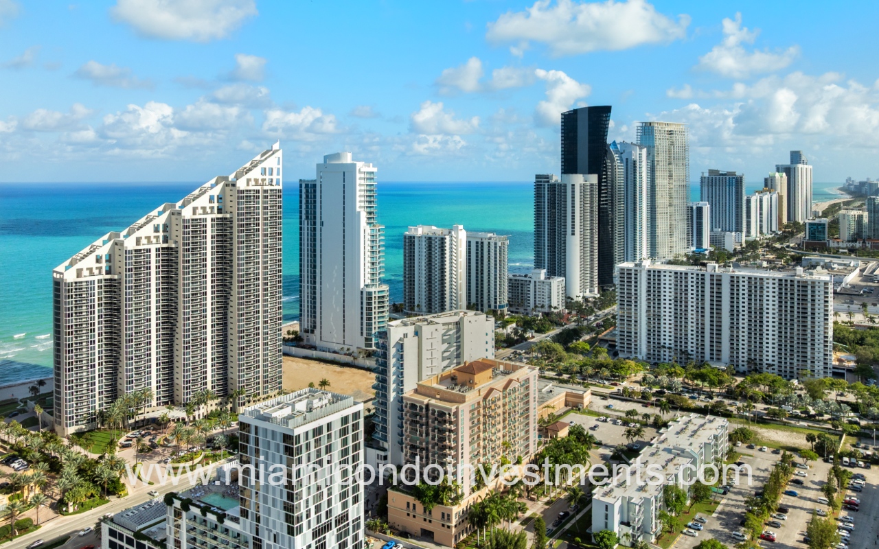 Aurora condo building drone view of area with skyscrapers and ocean in background