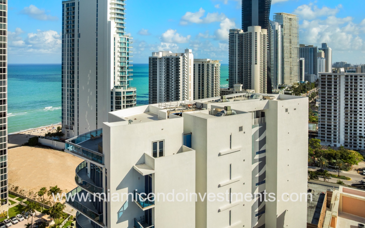 Aurora drone view of the top of condo building exterior and roof
