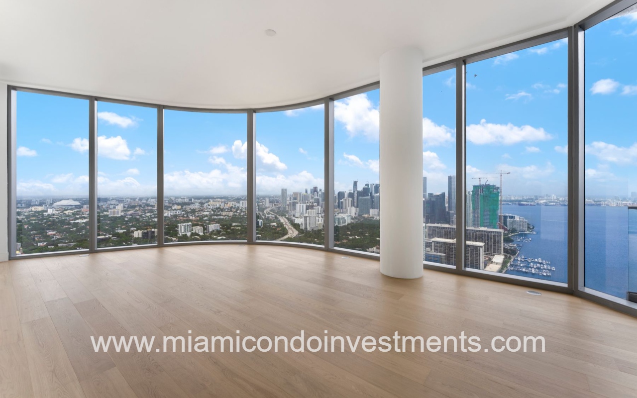 UNA Residences condominium building living room with floor-to-ceiling windows, skyline and water views