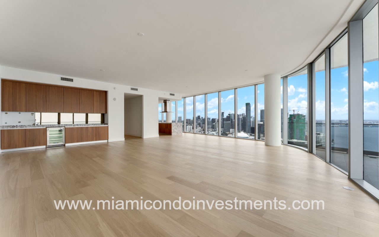 UNA Residences condominium view of living room with floor-to-ceiling glass