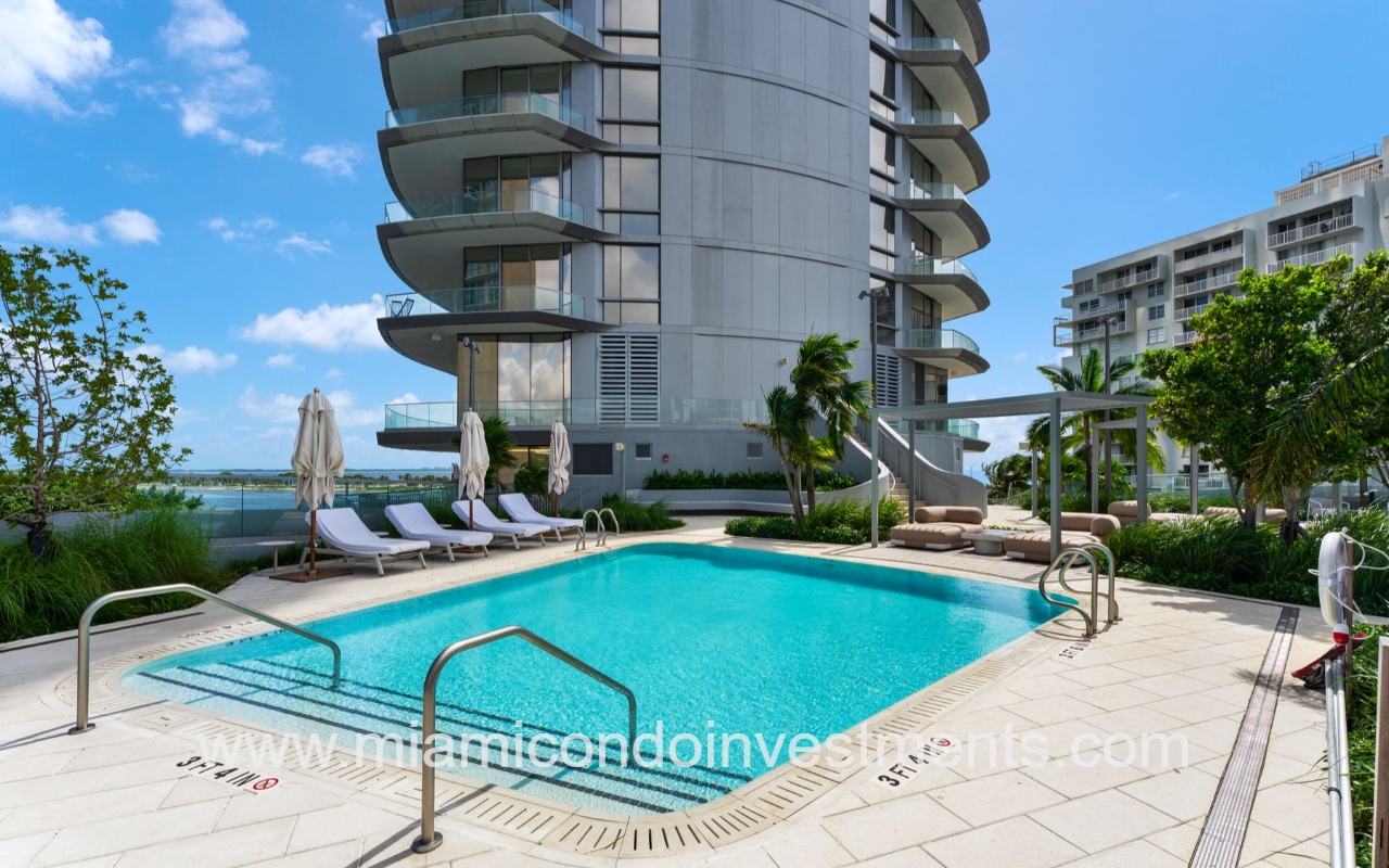 UNA Residences drone facing lower condominium building outdoor pool and pool area