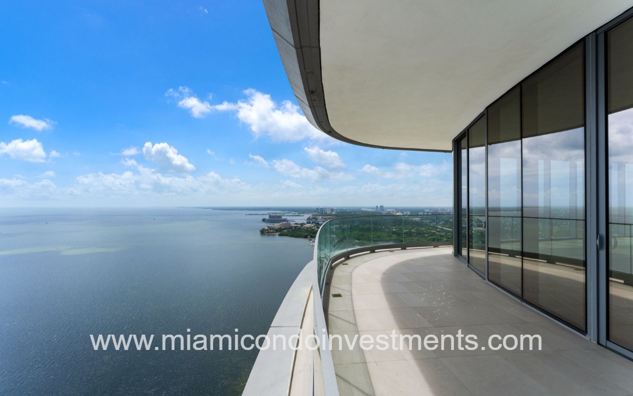 UNA Residences condominium building curved balcony with glass railing, overlooking Biscayne Bay