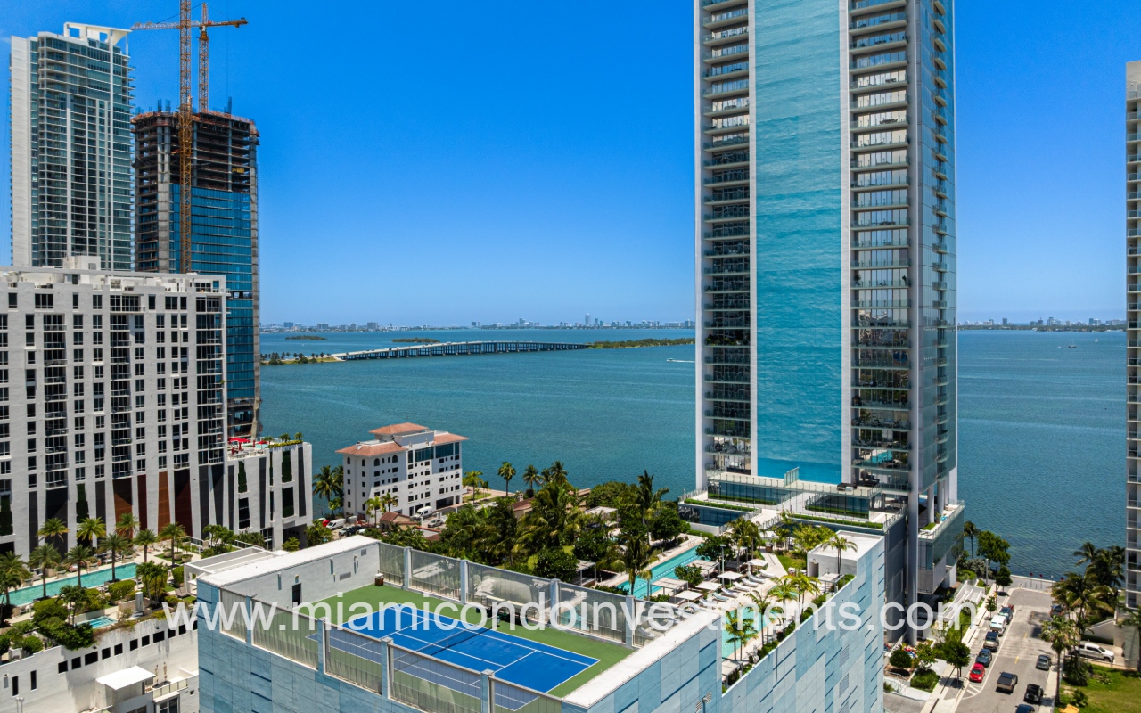 Missoni Baia drone view of condo building exterior with outdoor amenities overlooking bay