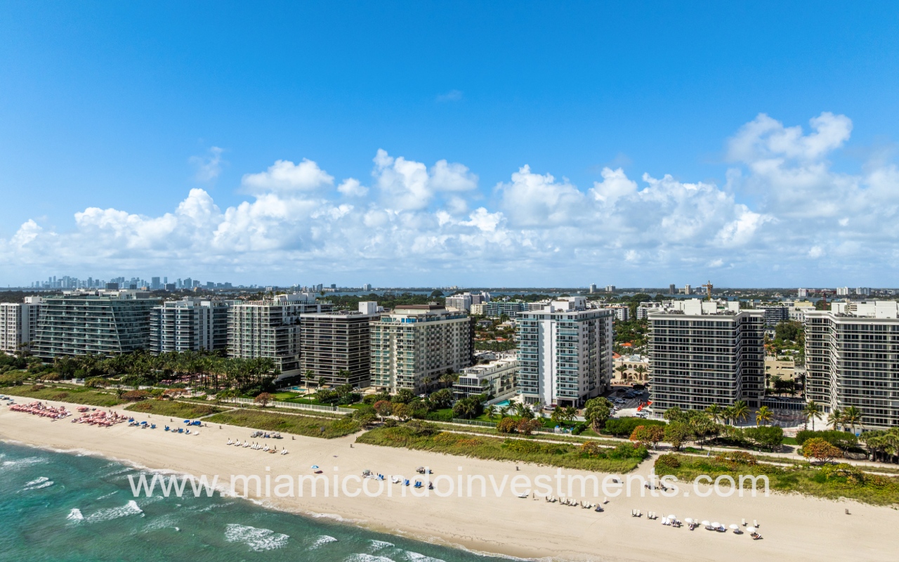 Ocean Seven drone view overlooking condo building and buildings along beach shoreline