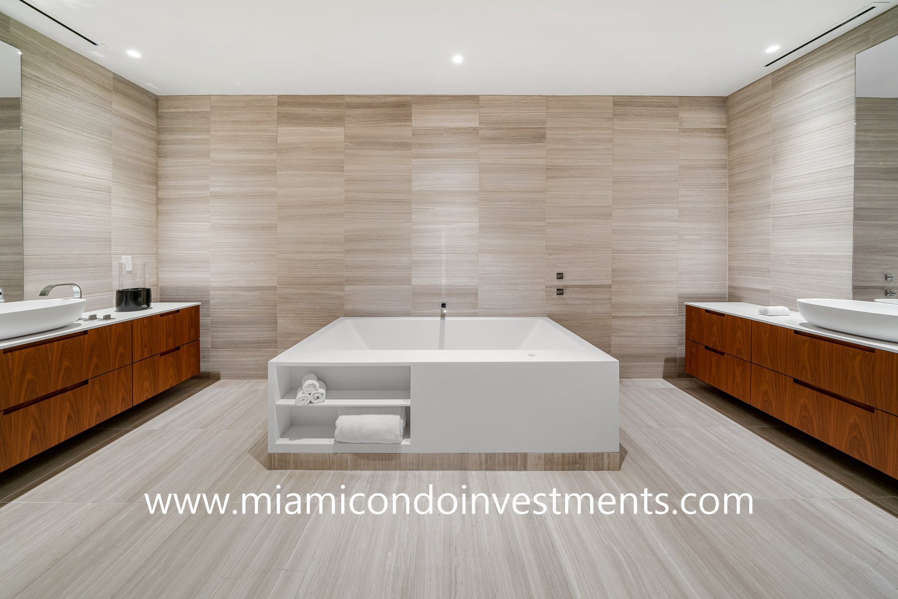 master bathroom with His and Hers vanities and soaking tub