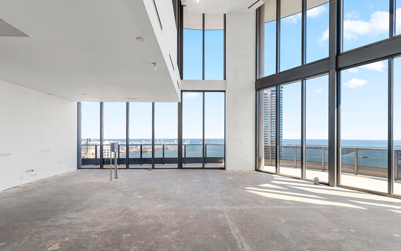 Double-height living room with soaring ceilings in Brickell Flatiron tri-level penthouse
