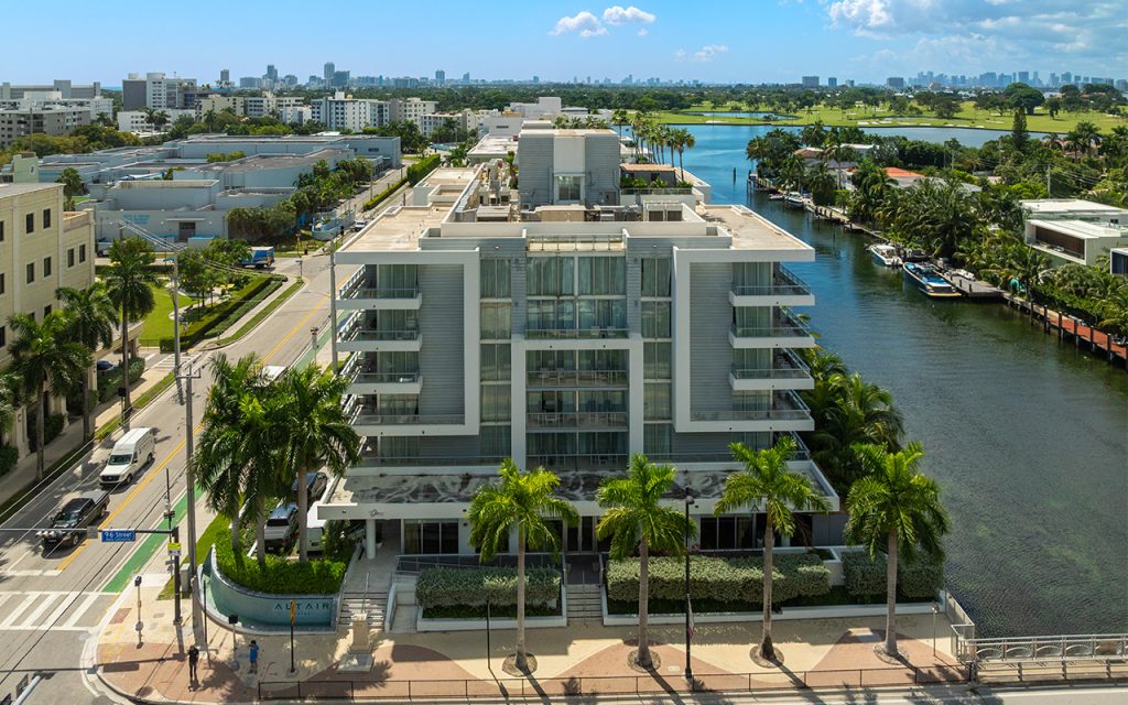 The Altair condo-hotel drone facing side angle building from waterway closeup