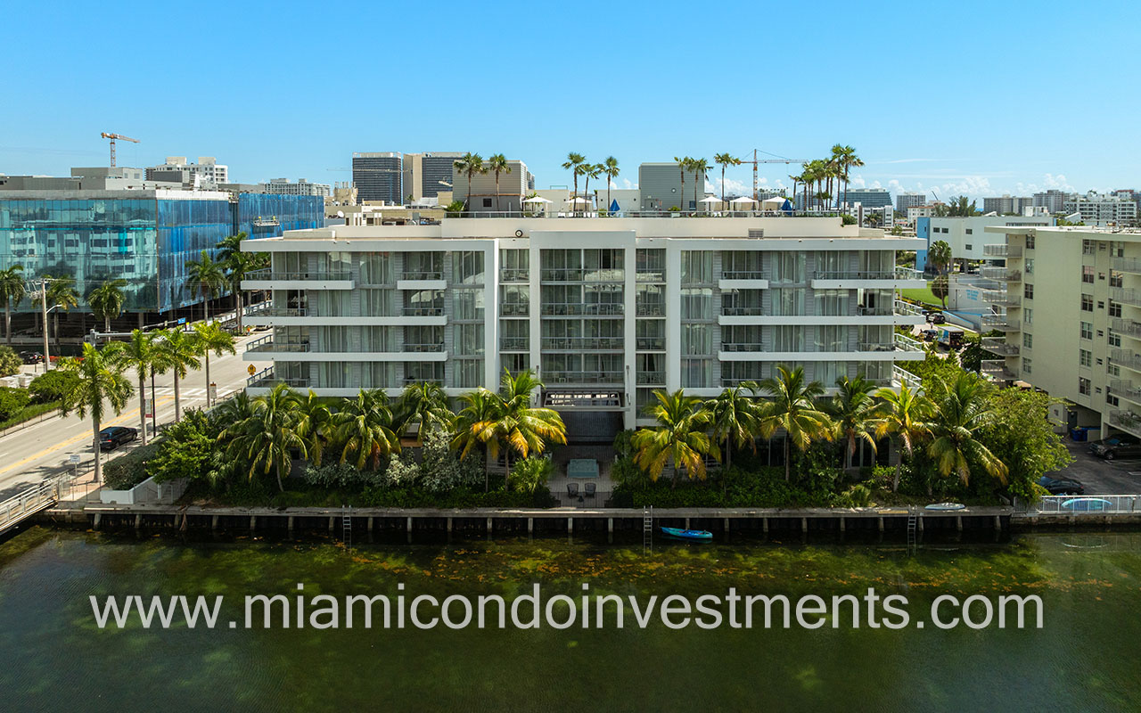 The Altair condo-hotel drone facing building from waterway closeup