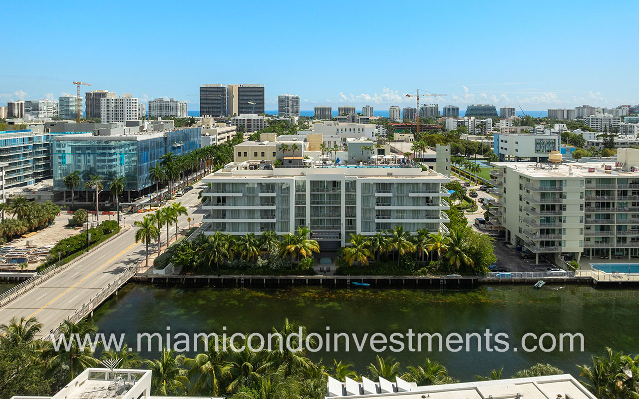 The Altair condo-hotel drone facing building from waterway