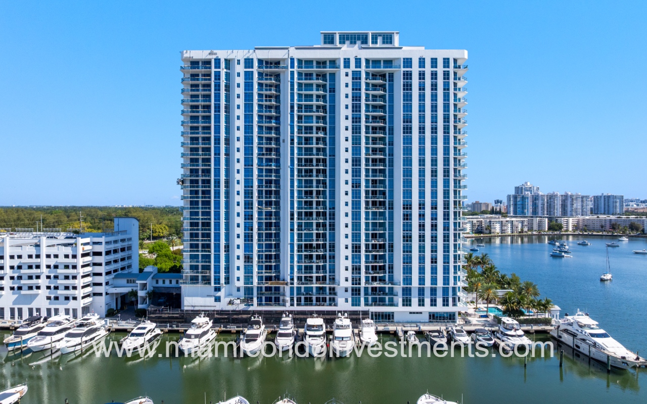 Marina Palms North drone closeup directly facing side of condo building from above marina
