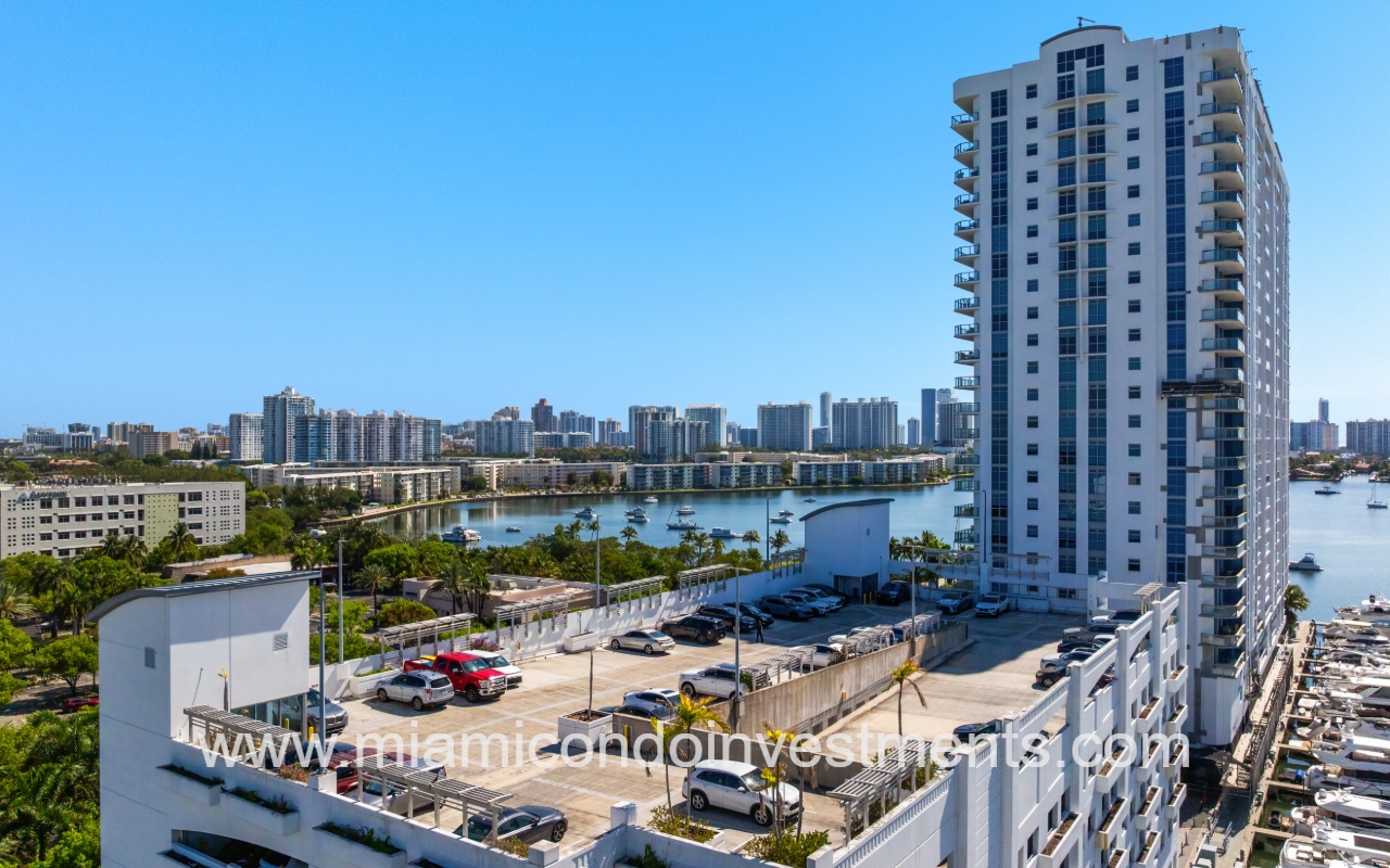 Marina Palms North drone overlooking the condo building with garage and buildings skyline