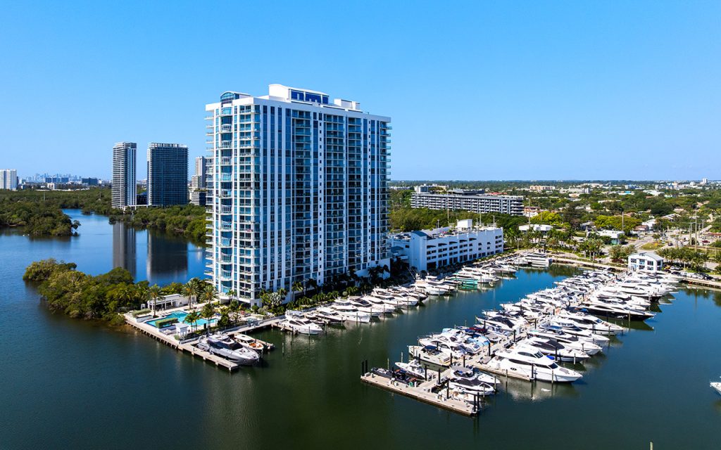 Marina Palms South drone angle view overlooking condo building from over marina