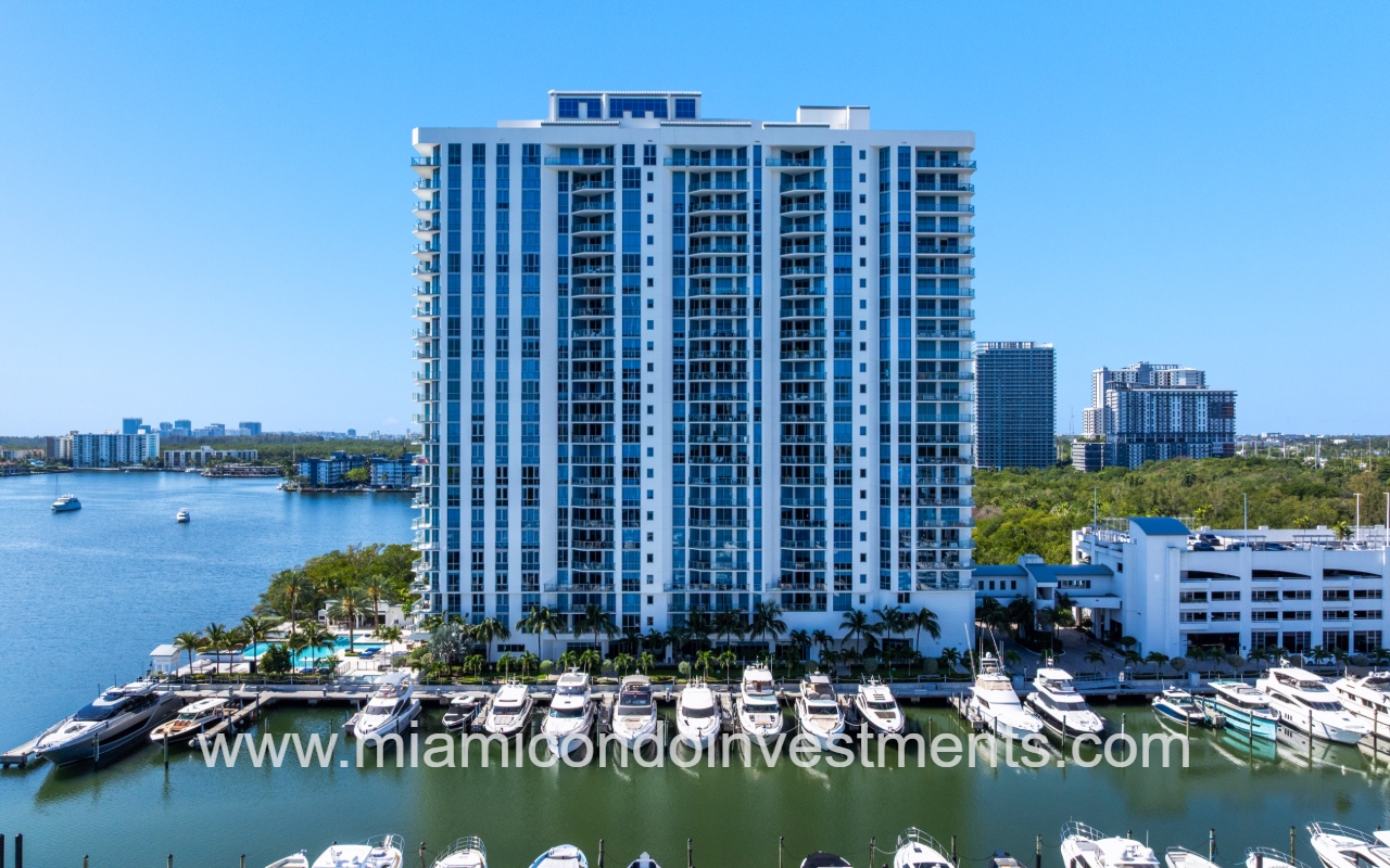 Marina Palms South drone view closeup facing side of condo building exterior with boats parked