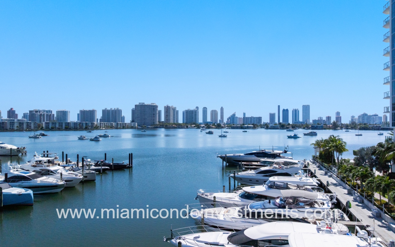 Marina Palms South drone view of marina with buildings skyline across waterway