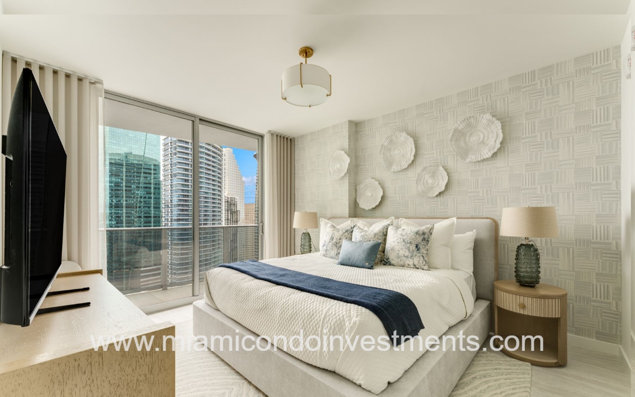 Viceroy Brickell primary bedroom with view of floor-to-ceiling glass and balcony